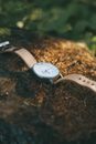 Analog Wristwatch with Leather Strap on the Ground