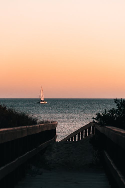 A Sailboat on the Sea during Sunset