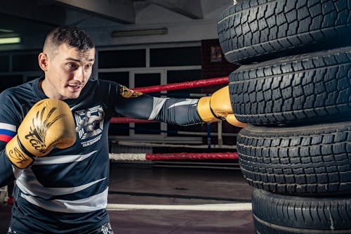 Man Punching the Tires at Gym 