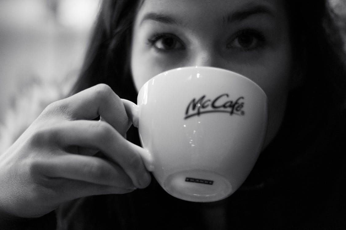 Free Grayscale Photography of Woman Drinking Coffee Stock Photo