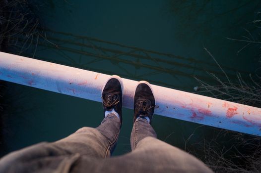 White Pipe Above Green Body of Water during Daytime
