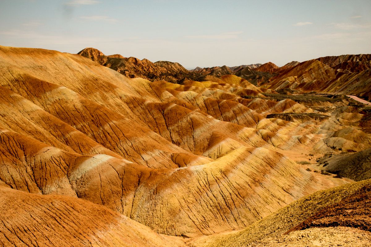 Zhangye Danxia's banded sandstone — 24 million years of mineral sediment exposed in a single hillside.