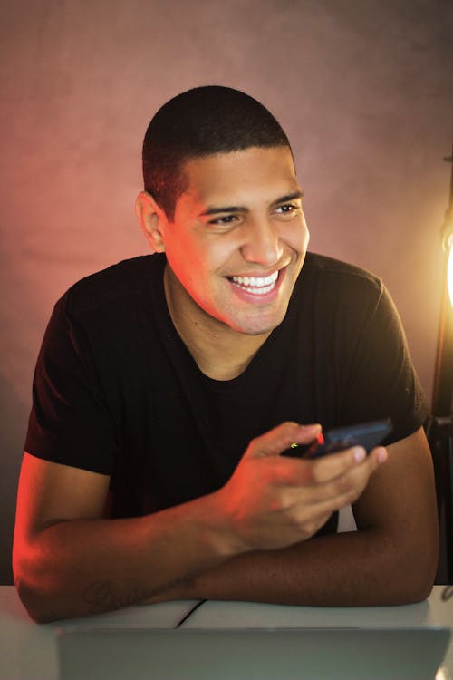 A Man Smiling using Smartphone