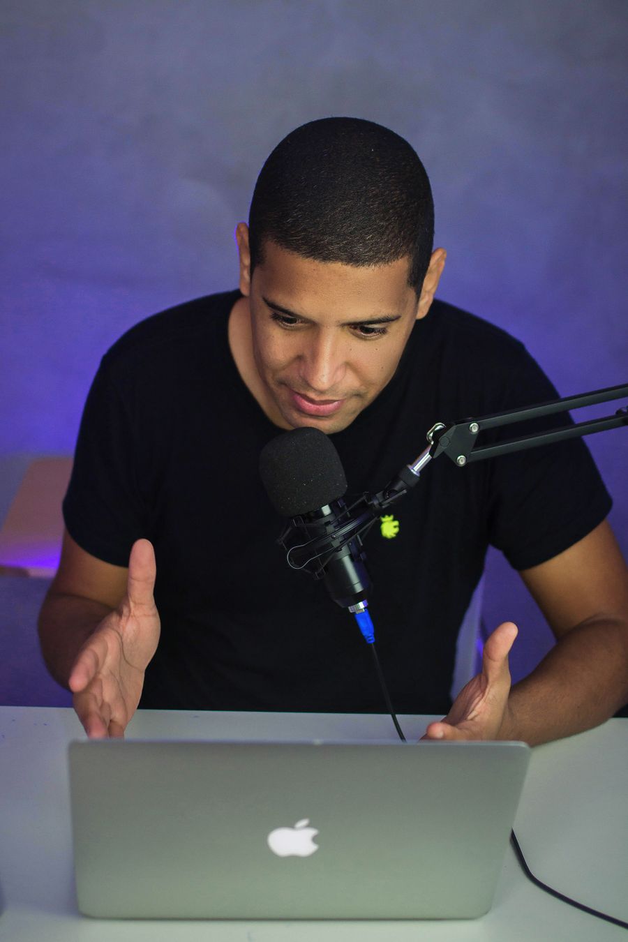 Portrait of Jordan Blake at a podcast microphone