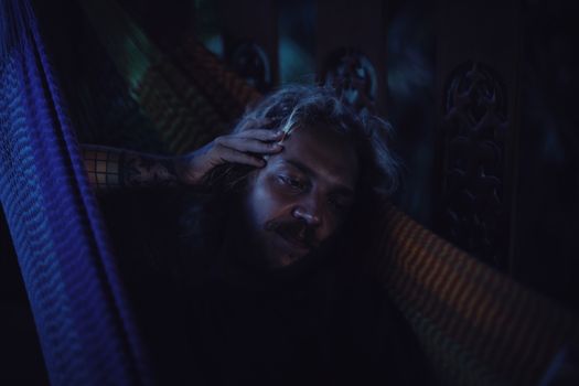 Man Lying in a Hammock