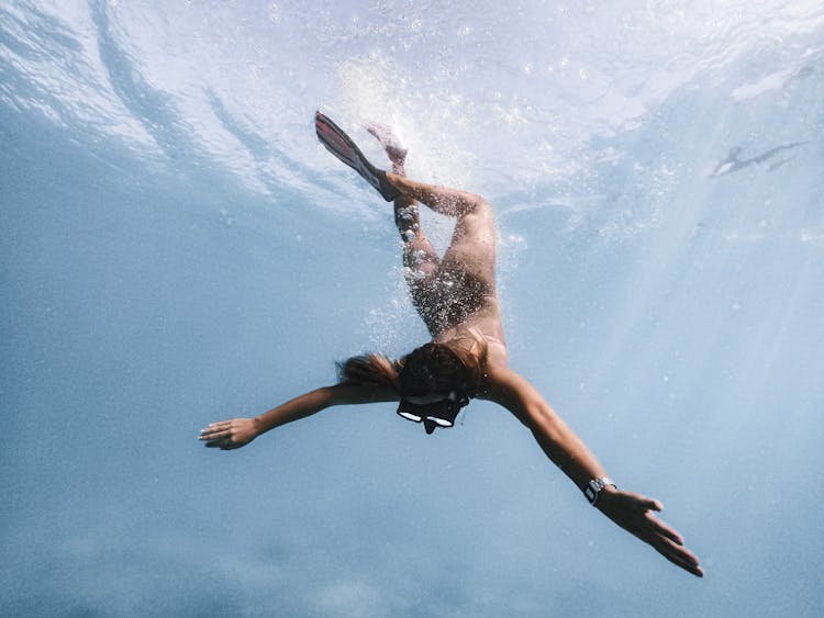 Woman Diving With Fins