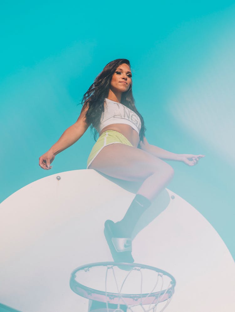 Cheerleader Sitting On Basketball Board