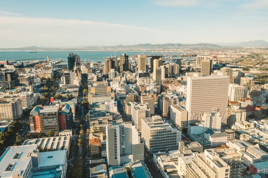 Aerial photograph showcasing a bustling city skyline with modern skyscrapers by the sea.