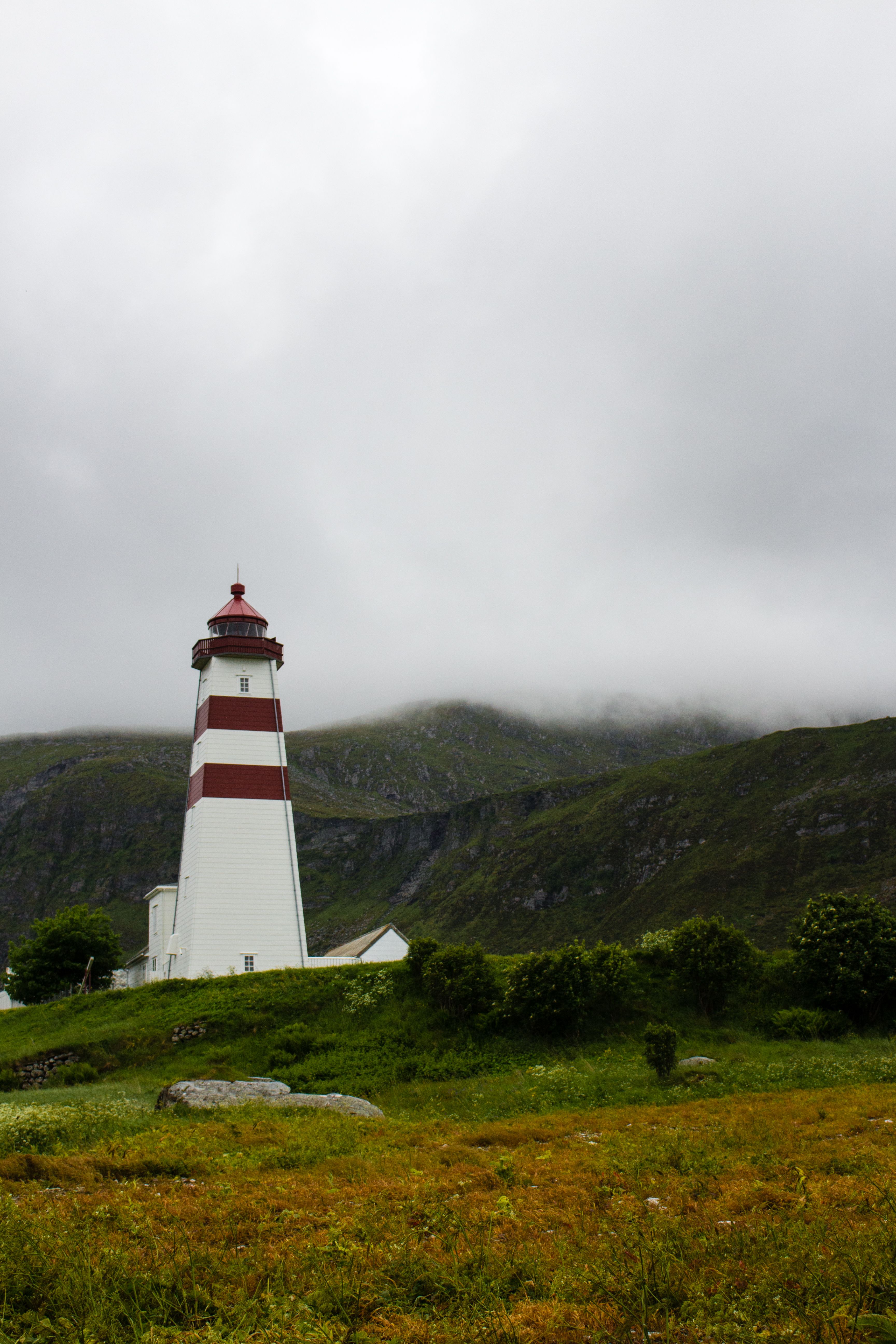 White and Red Lighthouse Under Cloudy Sky · Free Stock Photo