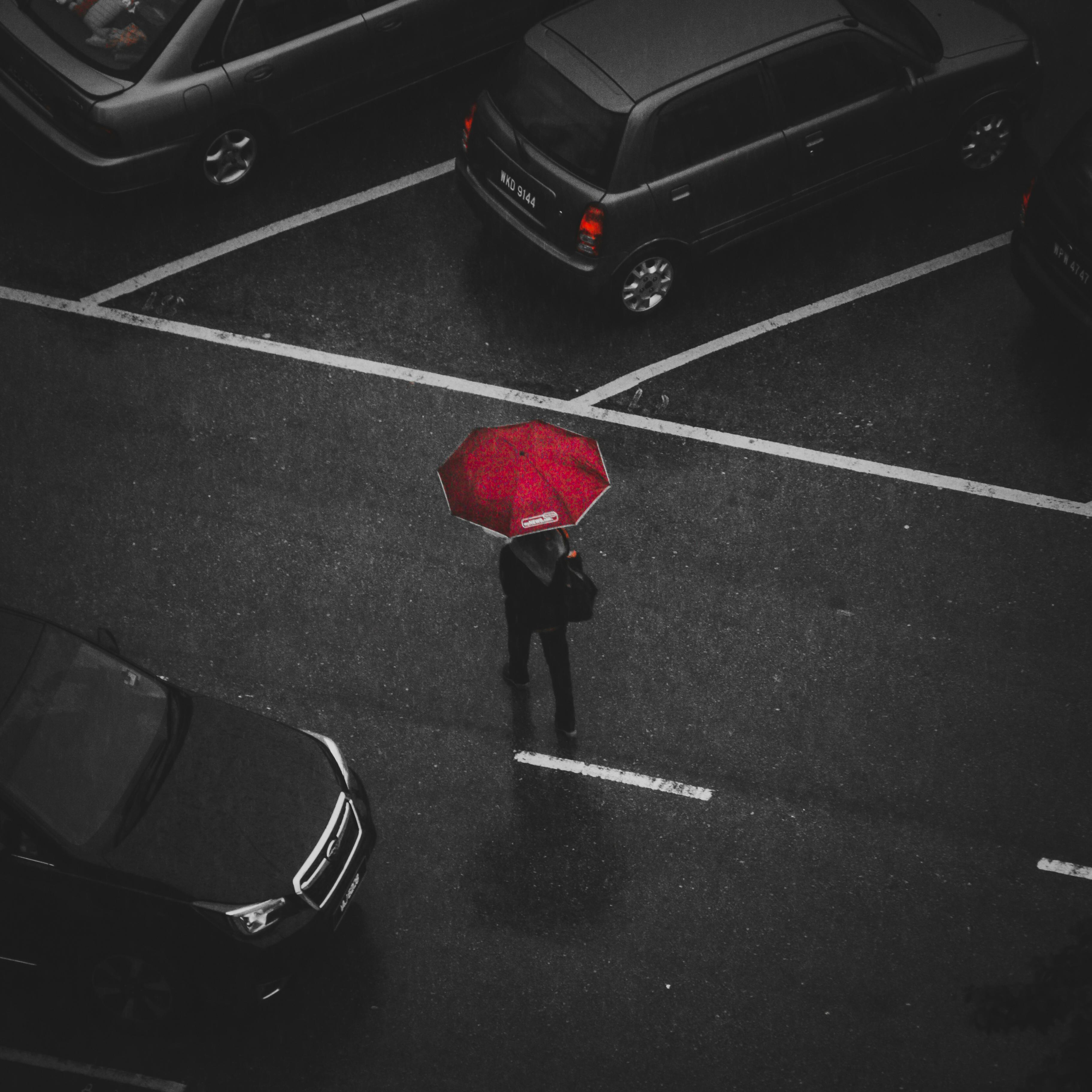 Person Holding Red Umbrella Walking on Street