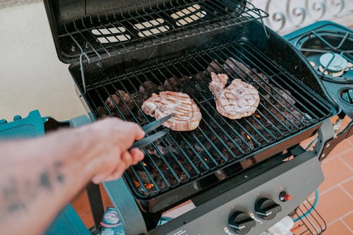 Person Grilling Meat