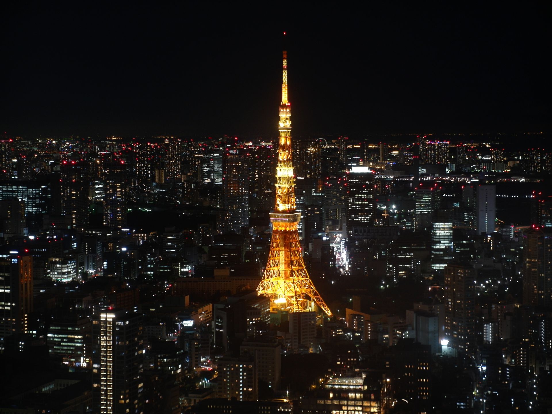 A stunning night view of Tokyo Tower glowing in the vibrant cityscape of Tokyo, Japan.