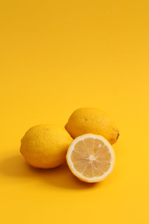 Yellow Lemon Fruits on Yellow Surface