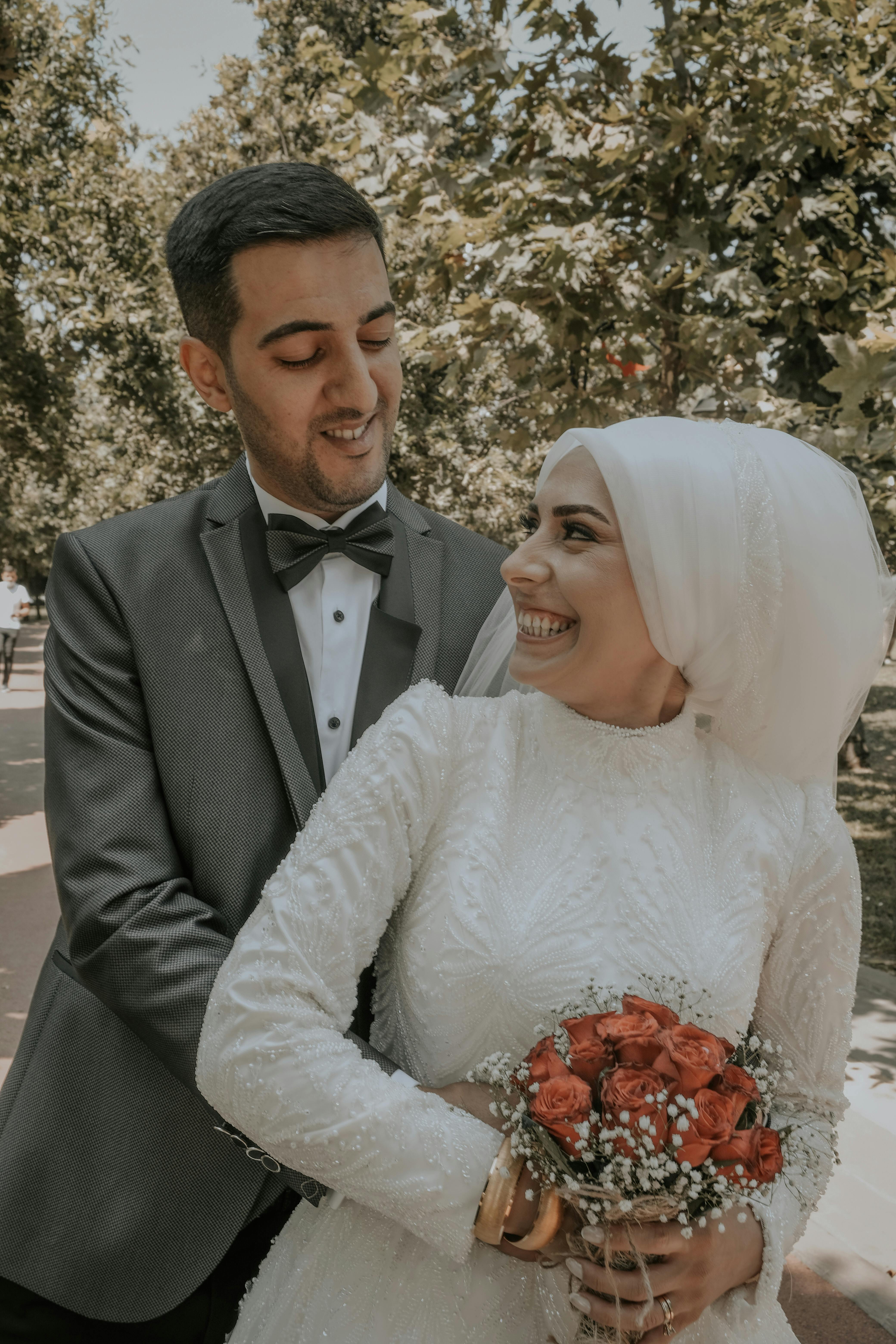 A Groom Hugging is Bride From Behind · Free Stock Photo