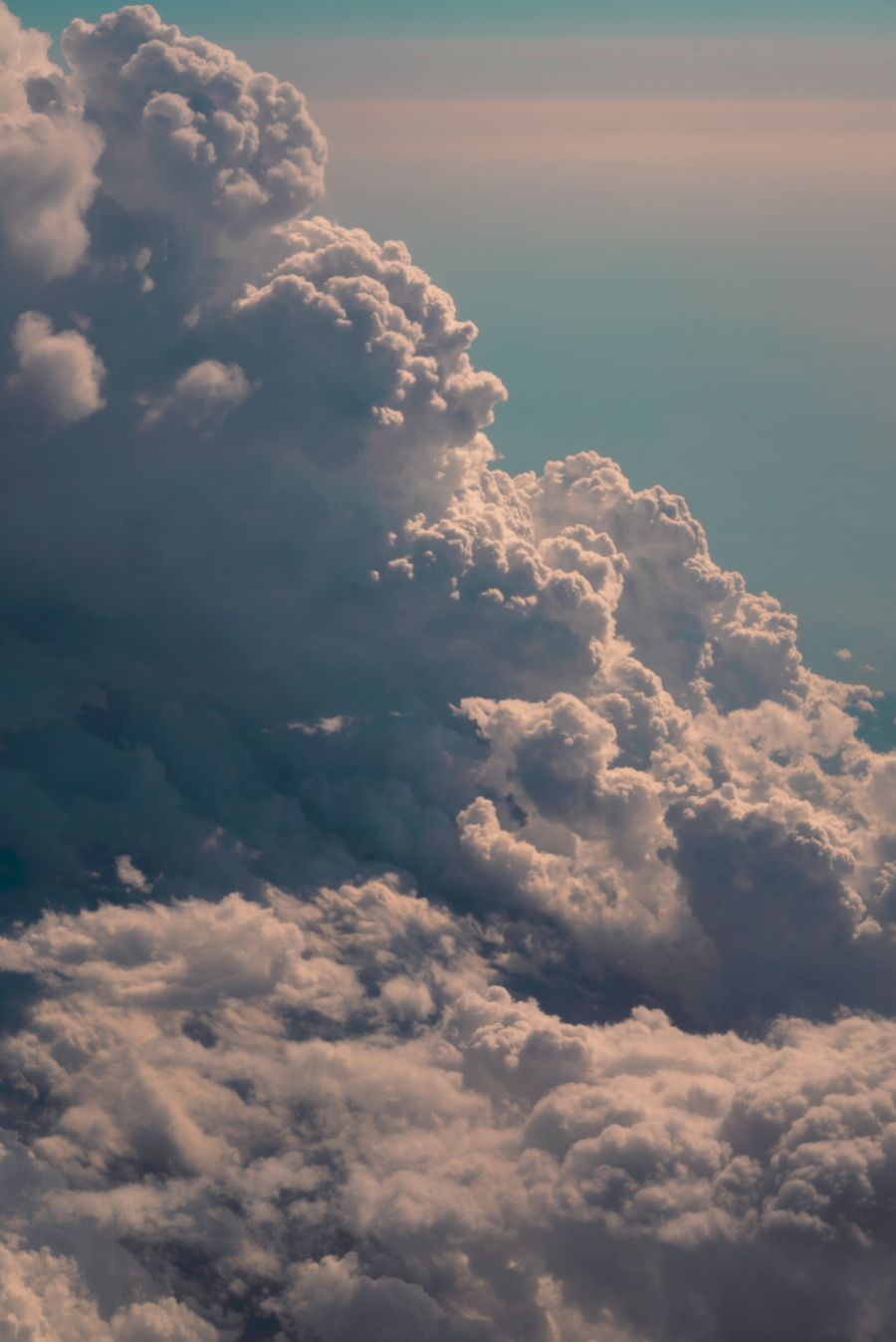 Towering cumulus clouds seen from above at dusk — photo by Last Stop Okinawa on Pexels