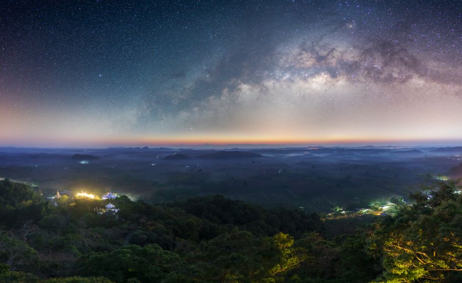 Captivating view of the Milky Way over Tambon Ton Yuan's lush landscape at night.