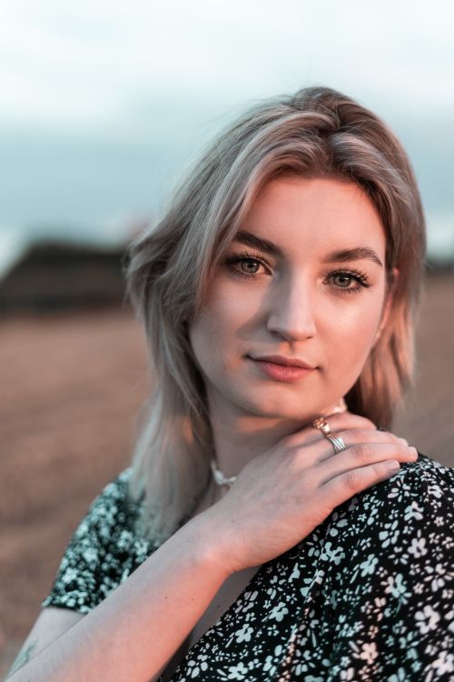 Free Charming portrait of a young woman outdoors in Polska wearing a black floral dress. Stock Photo