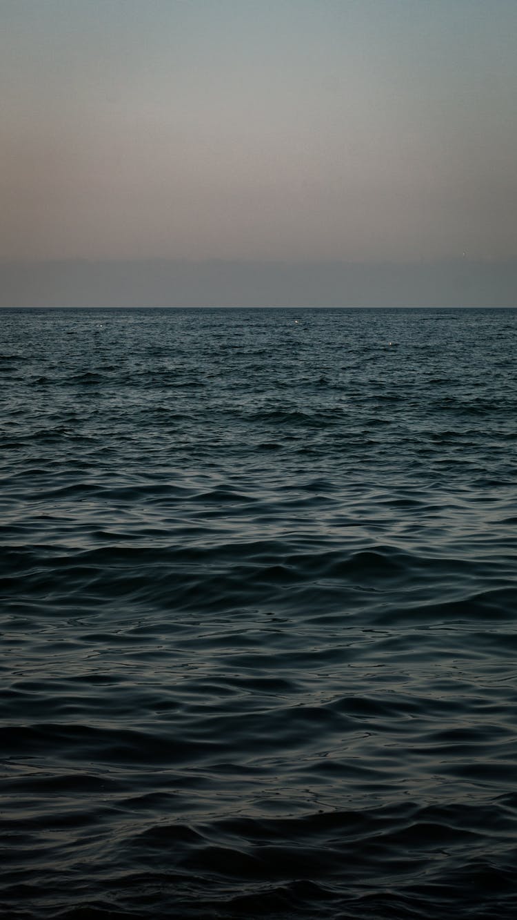 Wavy Sea Water Under Cloudy Sky