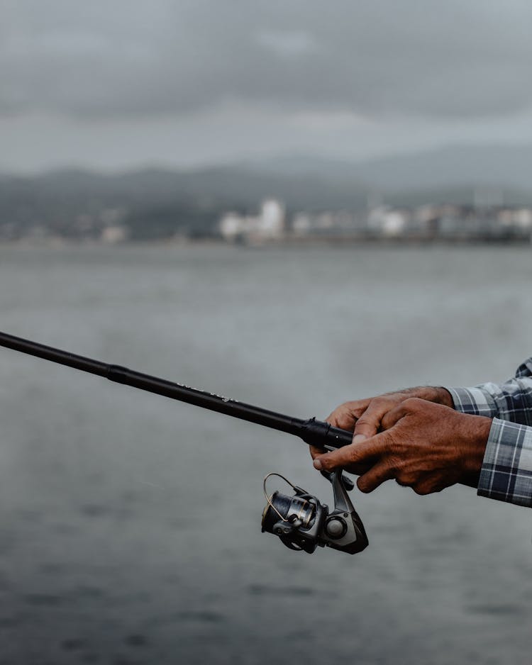 Crop Anonymous Fisherman Holding Fishing Rod