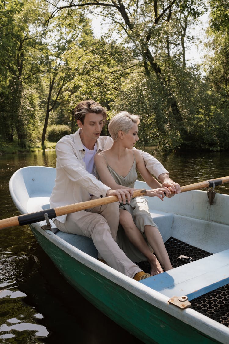 Man And Woman Paddling On A Boat