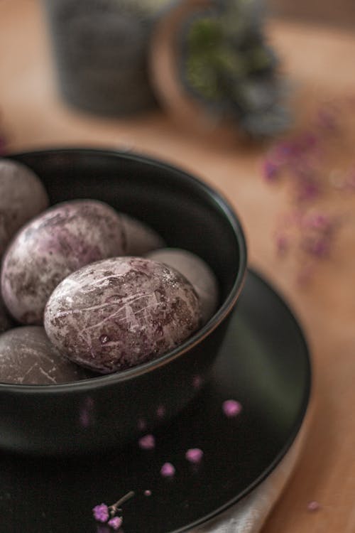 Painted Eggs on Black Ceramic Bowl