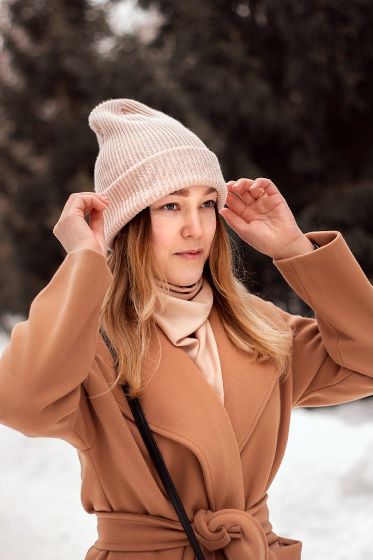 Woman In Brown Coat Wearing A Beanie