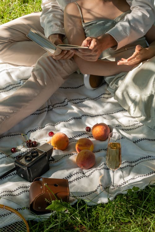 A Couple Sitting on Picnic Blanket