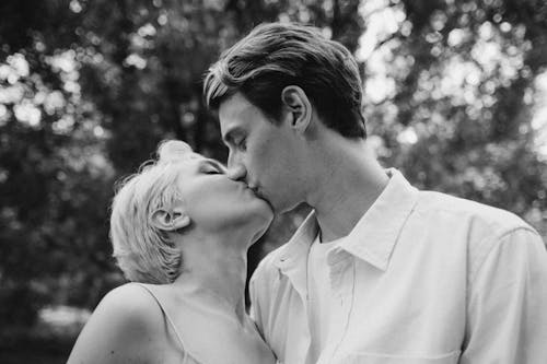 Grayscale Photo of a Couple Kissing 