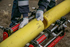 Plumber using advanced pipe detection equipment