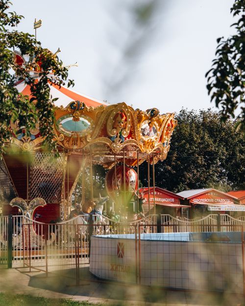Free A vibrant and detailed carousel captured at a sunny outdoor fairground, showcasing ornate designs. Stock Photo