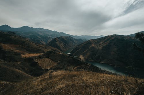 Photograph of Mountains Under White Clouds