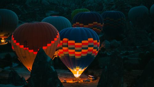 Free Colorful hot air balloons glow during a nighttime flight in Cappadocia, Türkiye. Stock Photo