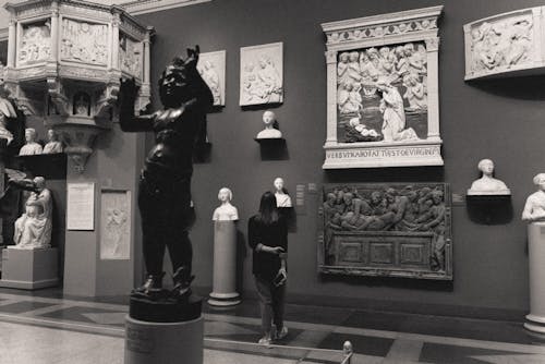 Woman Inside An Art Gallery Looking At The Exhibits