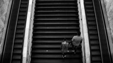 Man in White Long Sleeve Shirt and Black Pants Sitting on Stairs