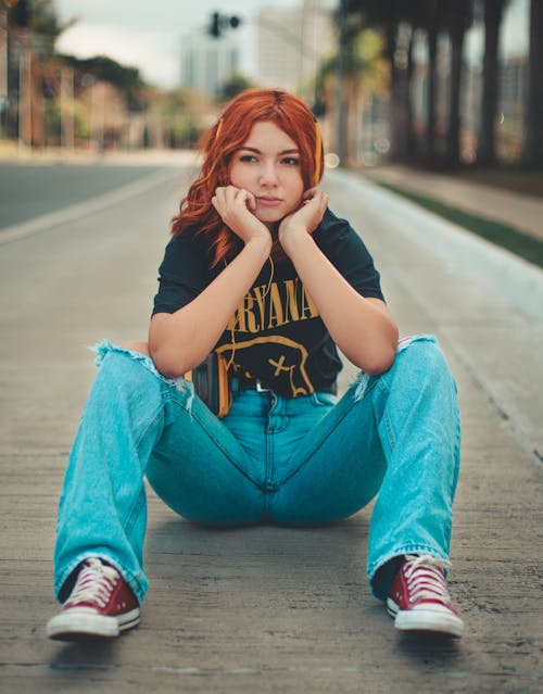Woman in Black Shirt and Denim Jeans Sitting on the Floor