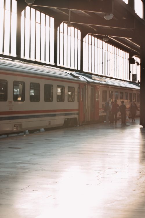 Free A sunlit train station platform in Ankara, Türkiye with passengers boarding. Stock Photo
