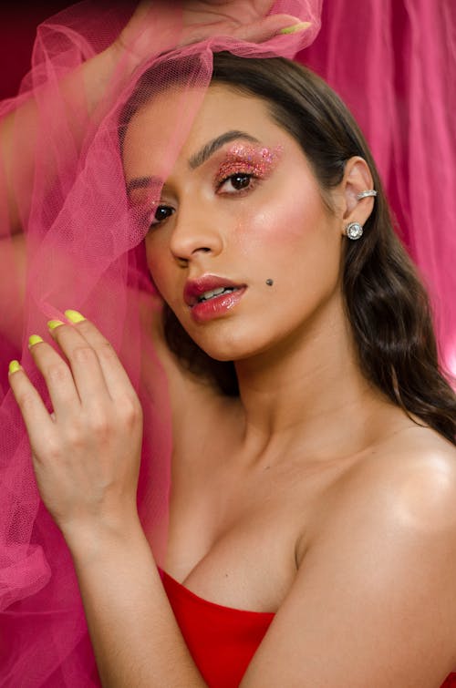 Portrait of a Woman Posing with a Pink Sheer Fabric