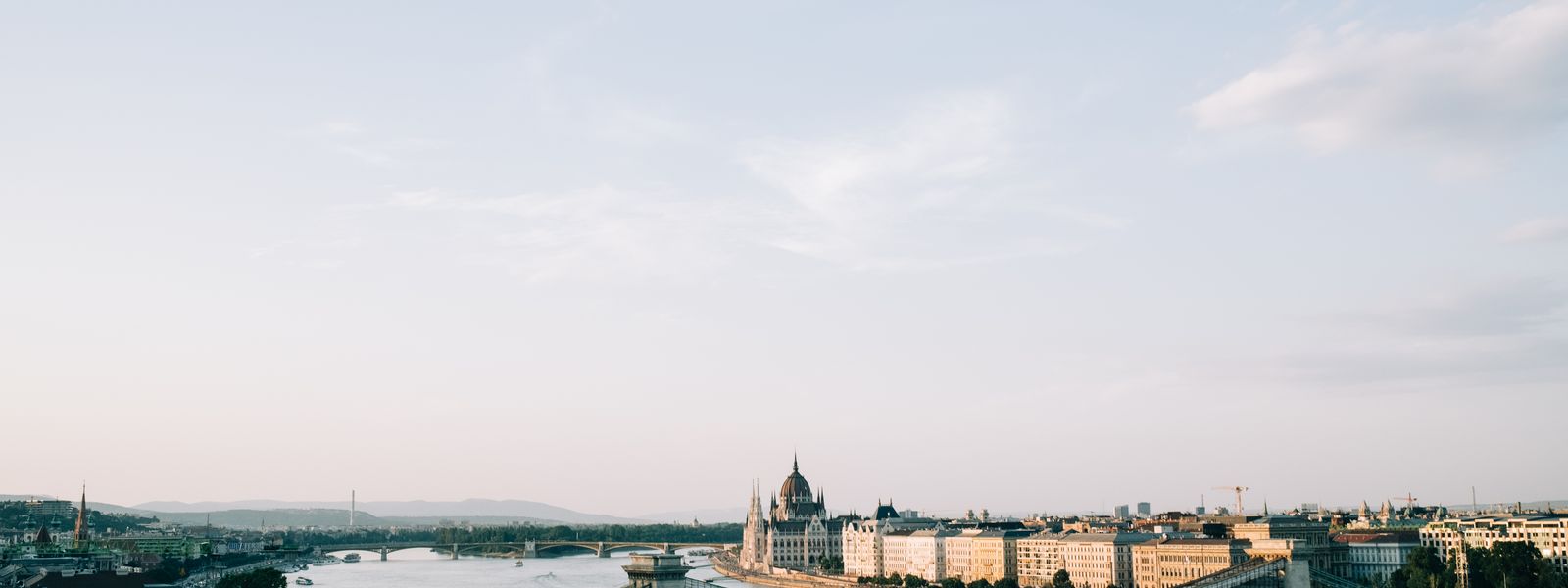 A picturesque view of Budapest featuring the Chain Bridge and Hungarian Parliament along the Danube River.