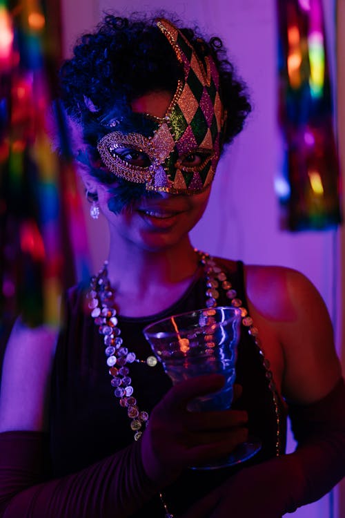 Woman in Masquerade Mask Holding Drinking Glass