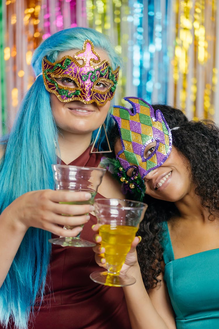 A Women Wearing Masquerade Mask While Holding Drinks