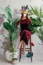 Woman in Red Dress Sitting on Brown Wooden Chair