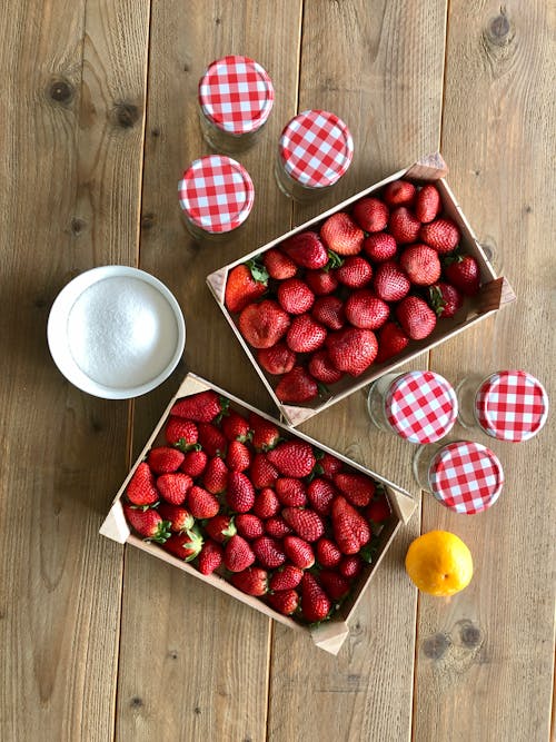 Free Strawberries and Glass Jars on a Wooden Table Stock Photo