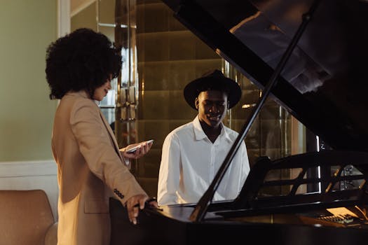 Two musicians in an elegant room play a grand piano, capturing a moment of musical creativity.