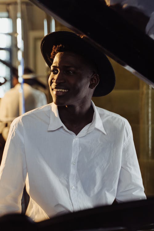 Man in White Long Sleeve Shirt Wearing a Hat