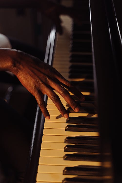 Hand on Piano Keys Playing Music