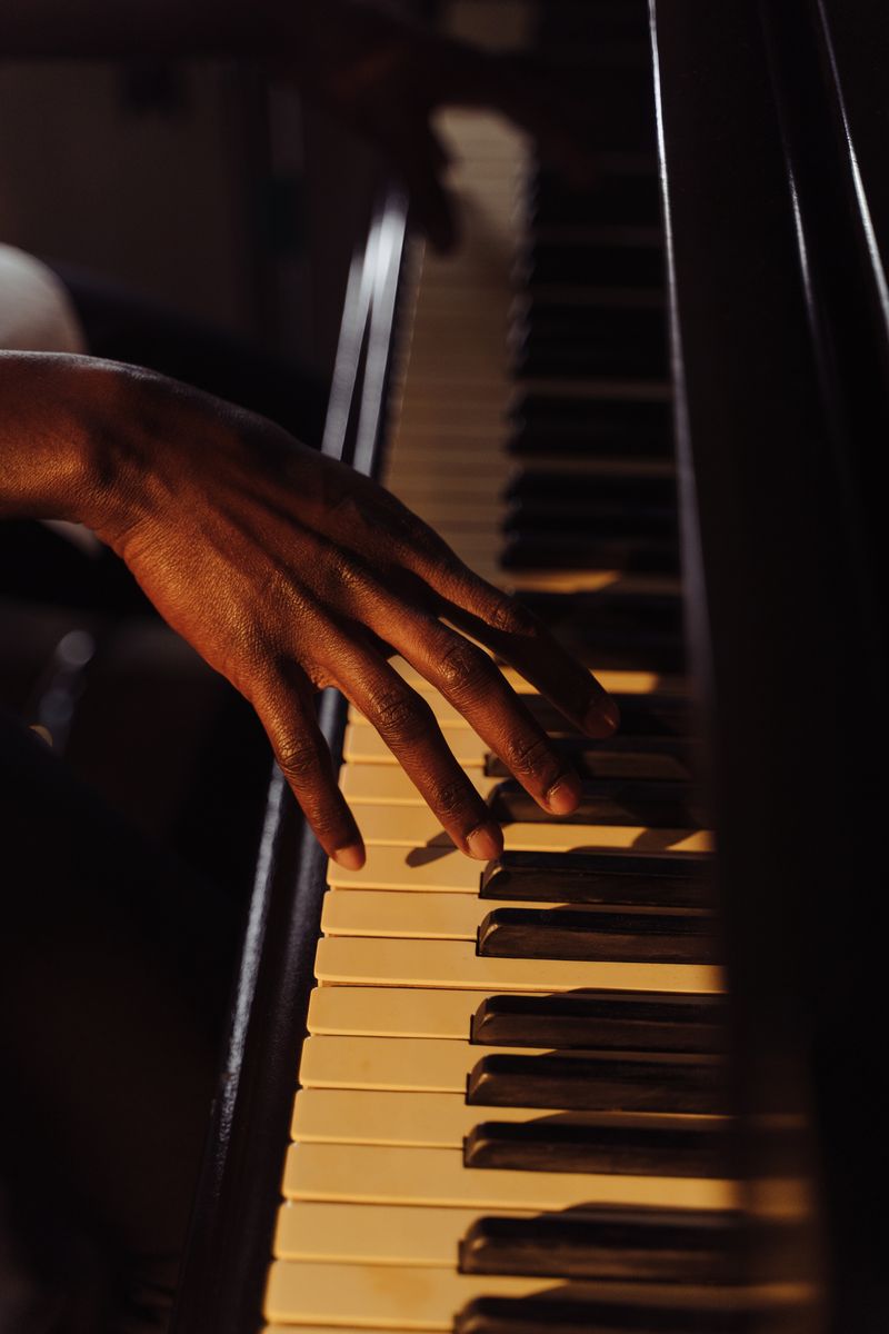 Hand playing piano keys