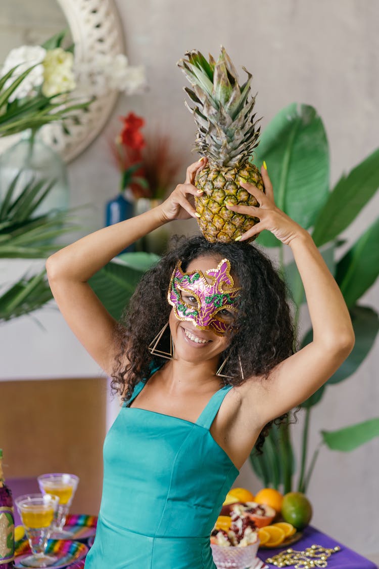 Woman Wearing Mask Holding A Pineapple