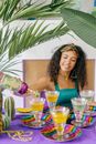 Woman in Green Spaghetti Strap Top Sitting on Chair