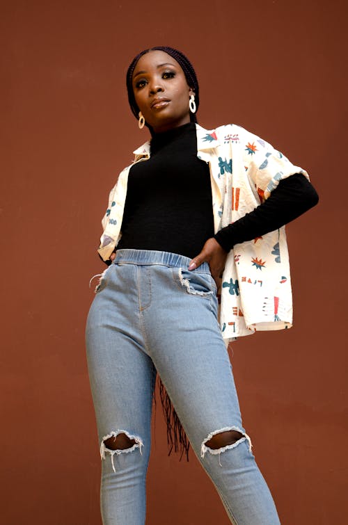 Woman in Denim Jeans Posing with Her Hands on Her Waist