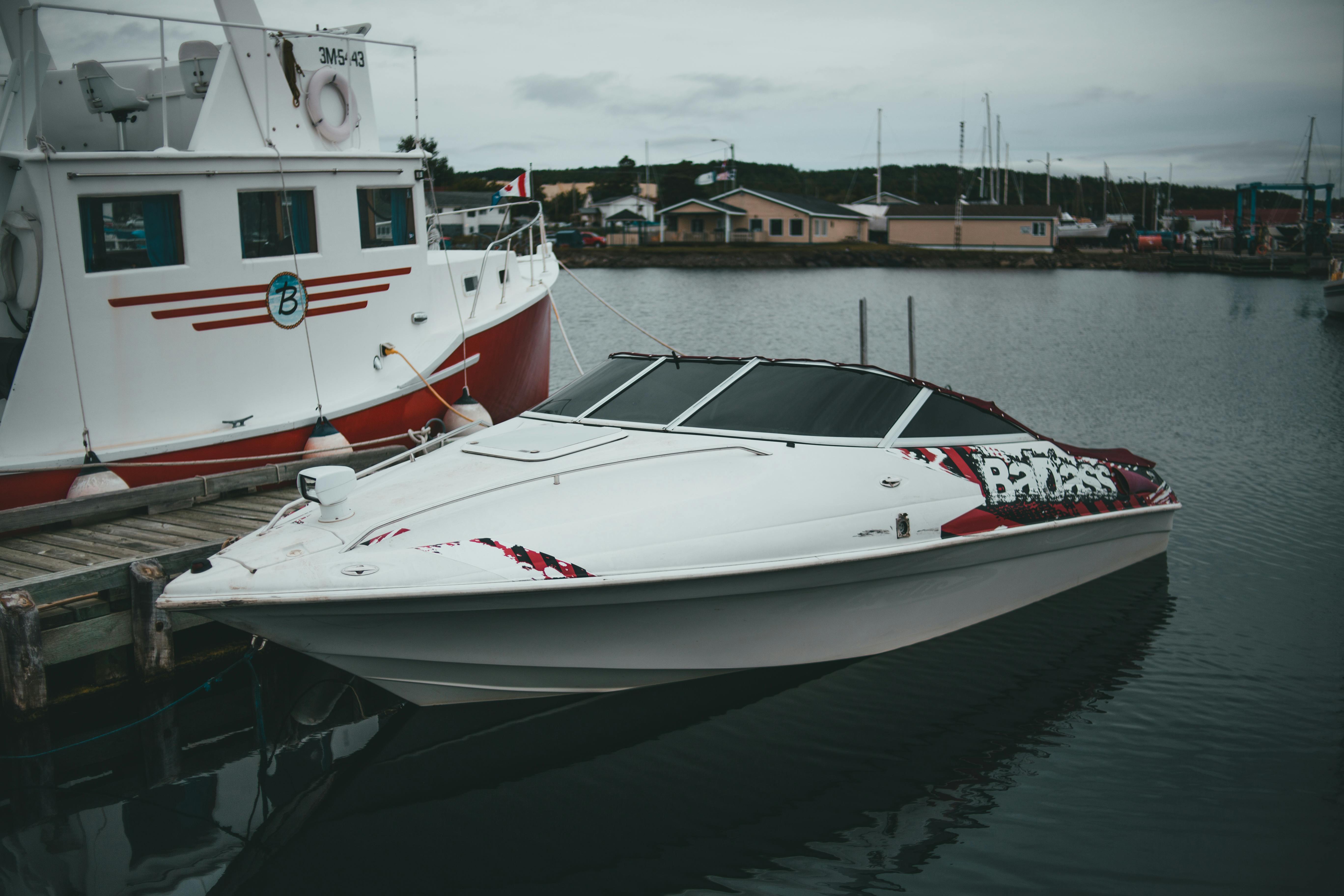 A boat securely tied to a modern floating dock in a long-term annual slip with high-quality lines and bumpers - annual boat slip rental